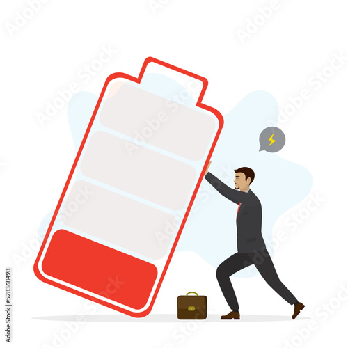 Recharge energy yourself. Hard work, overworked man. Fight burnout at work. Intolerance to burnout syndrome. Male employee trying to prevent large low battery from falling over it.