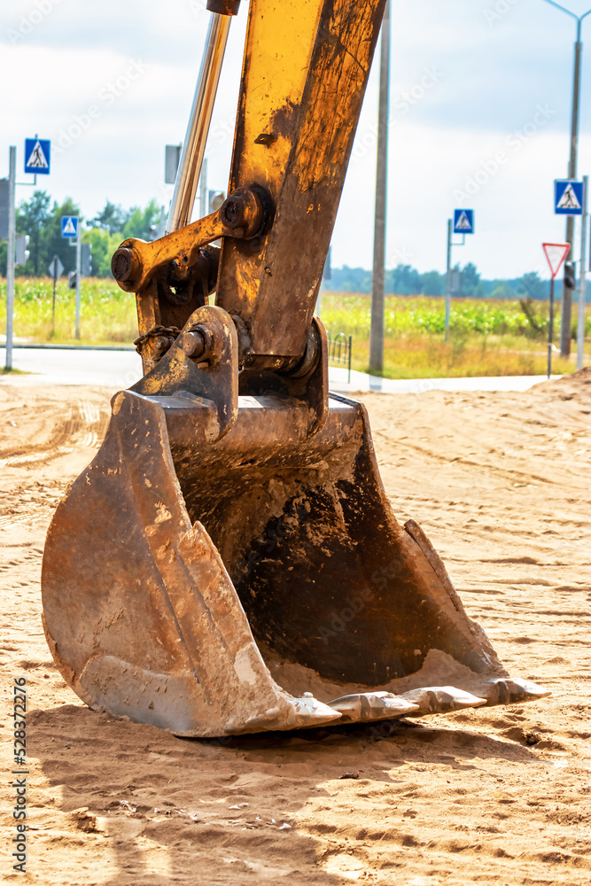Fototapeta premium Close up of excavator bucket at construction site. Construction equipment for earthworks.
