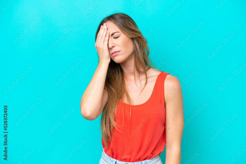 Young caucasian woman isolated on blue background with headache Young caucasian woman isolated on blue background with headache
