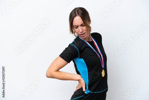Young caucasian woman with medals isolated on white background suffering from backache for having made an effort