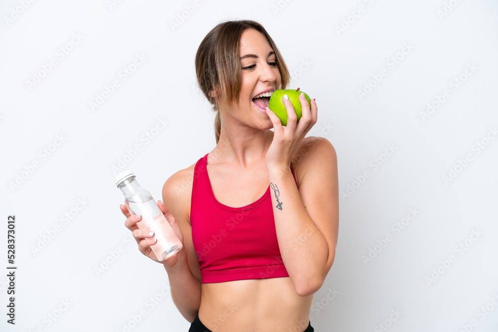 Young caucasian woman isolated on white background with a bottle of water and eating an apple Young caucasian woman isolated on white background with a bottle of water and eating an apple
