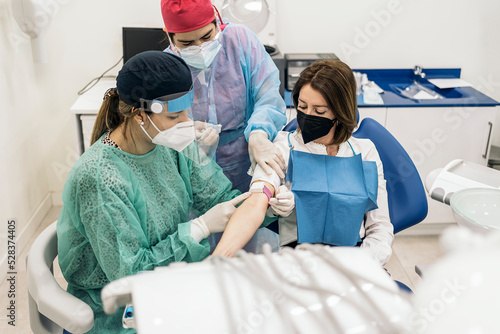 Doctor Drawing Blood in Hospital