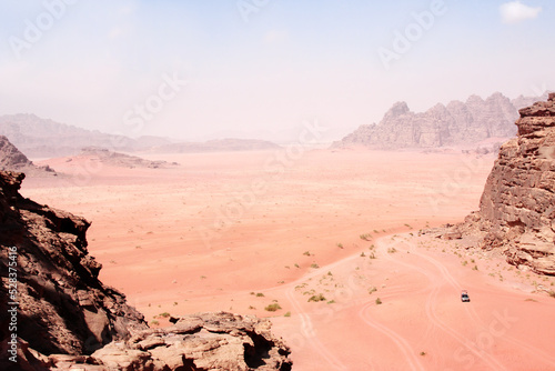 Car safari in Wadi Rum desert, Jordan. Tourists in car ride on off-road on sand among the beautiful rocks