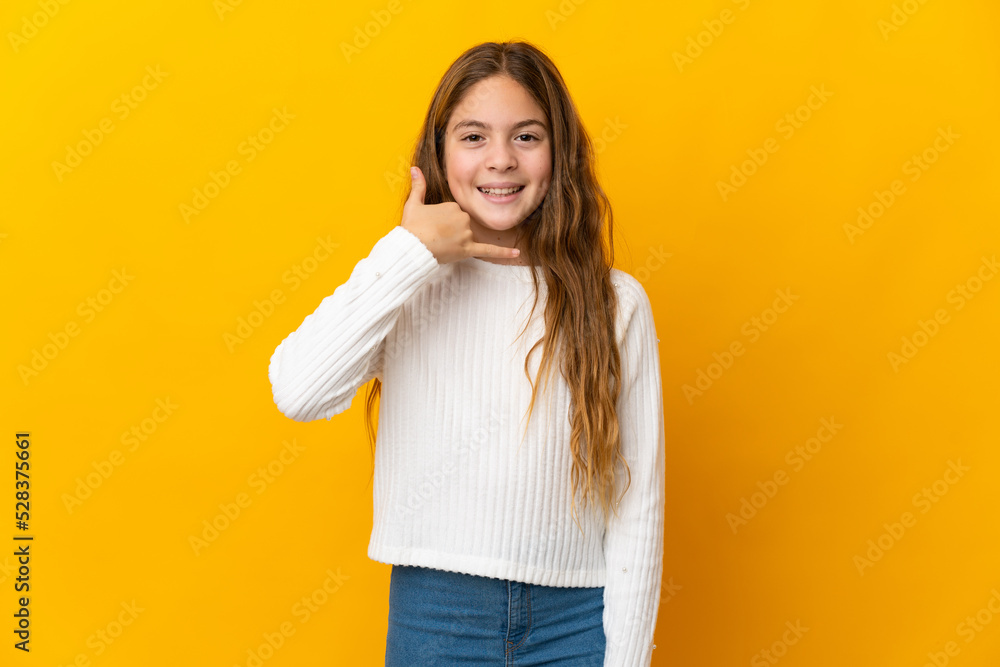 Child over isolated yellow background making phone gesture. Call me back sign Child over isolated yellow background making phone gesture. Call me back sign