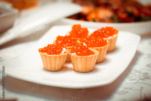 Tartlets with red caviar close-up, a dish with tartlets, festive food, selective focus