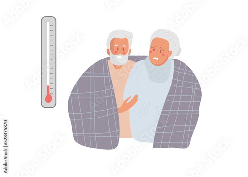 Elderly woman and man looking at thermometer and freezes. Elderly people try to keep warm under blanket. Suffering from cold. Dissatisfied Senior woman and man having problem with central heating
