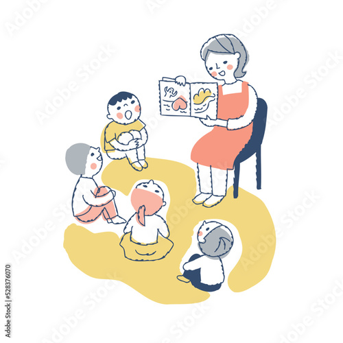絵本の読み聞かせをする保育士と子供たち
