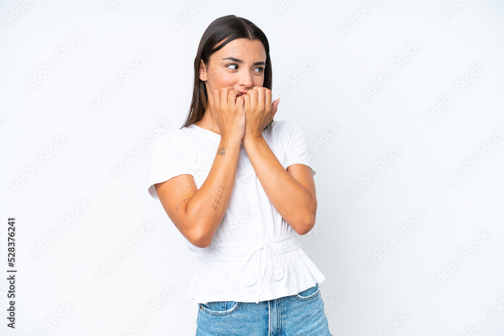 Young caucasian woman isolated on white background nervous and scared putting hands to mouth Young caucasian woman isolated on white background nervous and scared putting hands to mouth