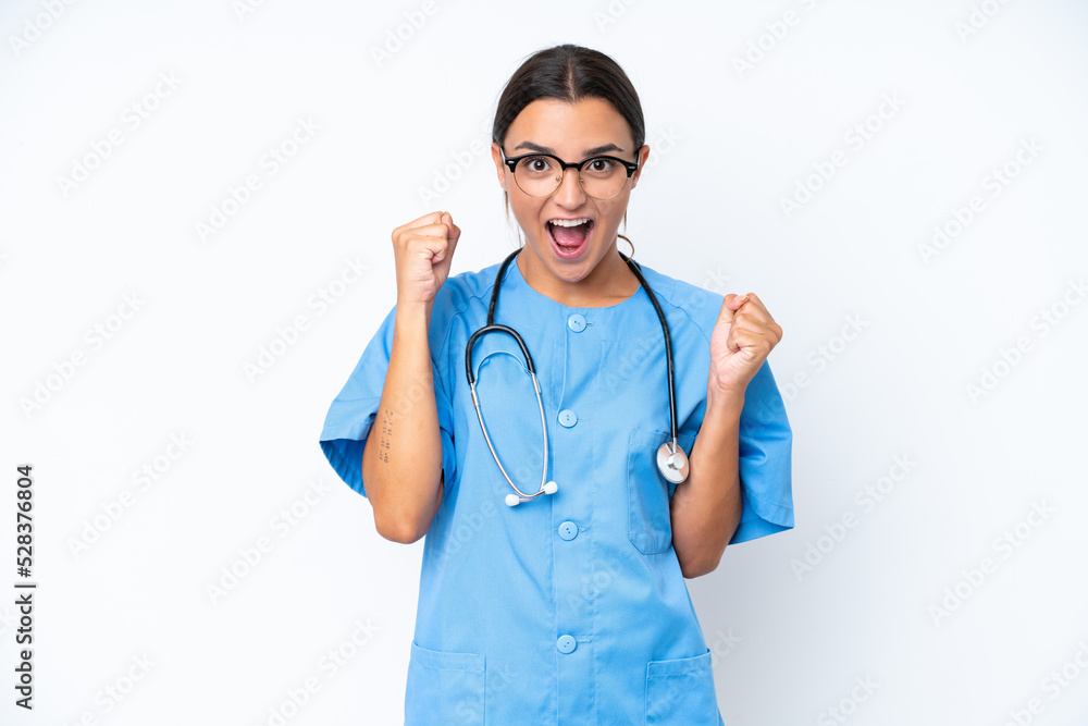 Young nurse woman isolated on white background celebrating a victory in winner position Young nurse woman isolated on white background celebrating a victory in winner position