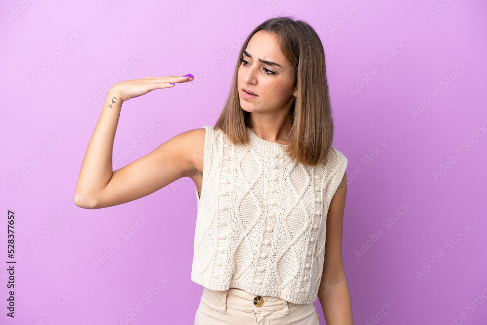 Young caucasian woman isolated on purple background with tired and sick expression Young caucasian woman isolated on purple background with tired and sick expression