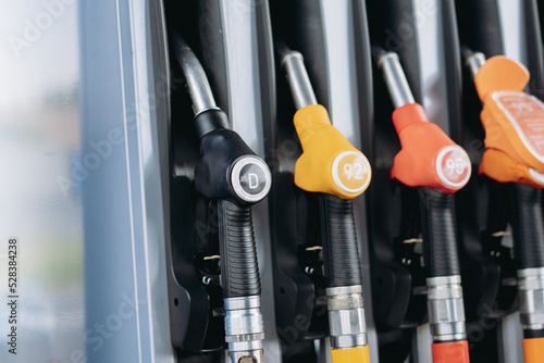 petrol pump filling fuel nozzles at gas station