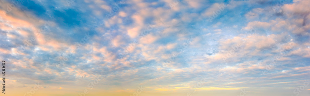 Panoramic sunset sky. Overcast clouds in pastel colors. Only the sky.