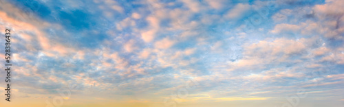 Panoramic sunset sky. Overcast clouds in pastel colors. Only the sky.
