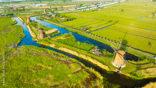 An aerial view of the windmill. Kinderdijk national park. Canals with water for agriculture. Fields and meadows. Landscape from the air.