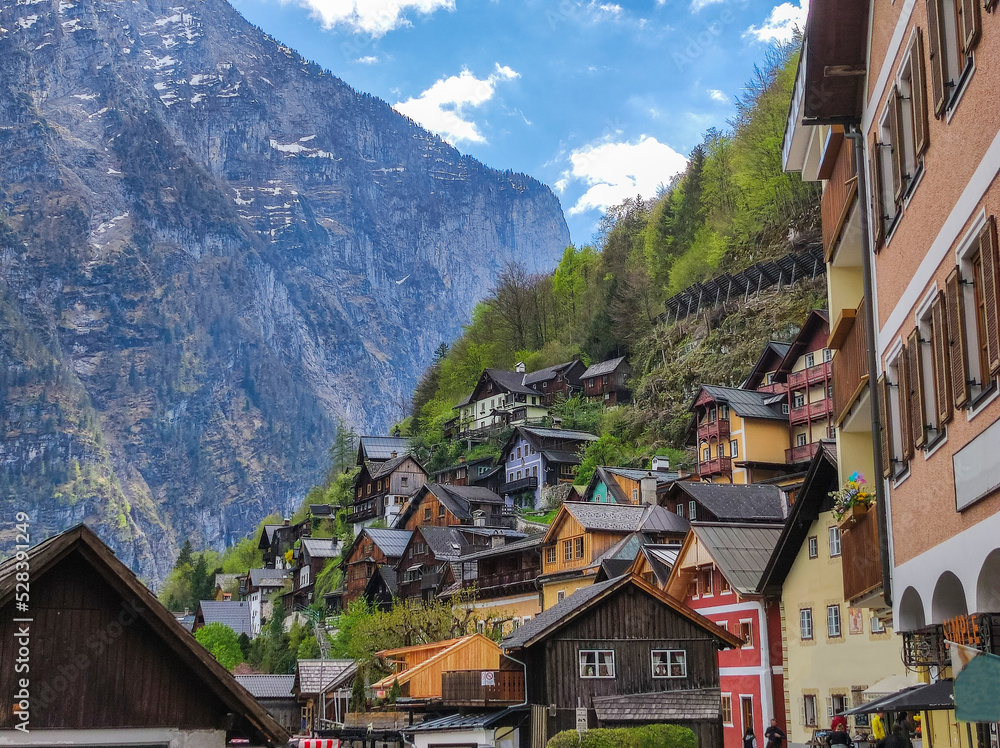 Typical colorful traditional Austrian cottages on the slopes of the Alps in the town of Hallstatt.  Popular tourist destination in Austria