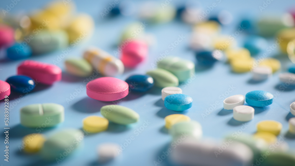 Pharmacy background on a table. Tablets on a blue background. Pills. Medicine and healthy. Close up of capsules. Different kind of medicines Pharmacy background on a table. Tablets on a blue background. Pills. Medicine and healthy. Close up of capsules. Different kind of medicines