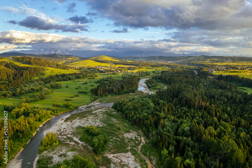 Fototapeta Naklejka Na Ścianę i Meble -  Bialka River in Podhale region, High tatras mountains in Poland at sunset. Drone View