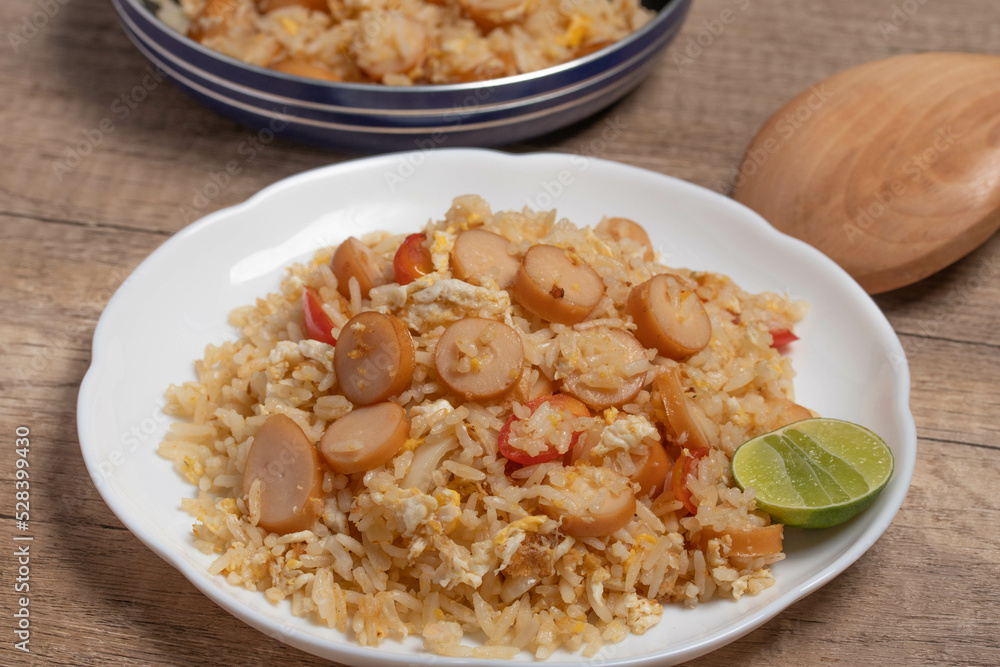 Sausage fried rice with egg and vegetables in white plate Sausage fried rice with egg and vegetables in white plate