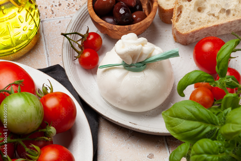 Burrata cheese, various tomatoes and olives Burrata cheese, various tomatoes and olives