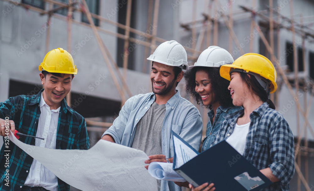 African American and Asian architects helped to construct the building.Engineer workers wear safety helmets.Professional staff planning industrial work. African American and Asian architects helped to construct the building.Engineer workers wear safety helmets.Professional staff planning industrial work.
