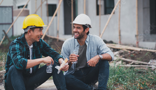 Engineering men are helping to plan the construction of the building.Engineer workers wear safety helmets.men at industrial work.