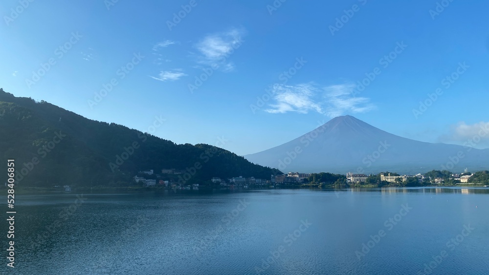 Mt. Fuji on a clear sky, defined lines of the gentle slope and the high point of tip is visible, a summer morning scenery at Kawaguchiko lakeshore, year 2022 August 27th