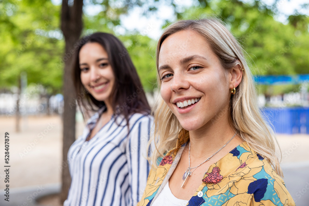 Happy blond woman with friend at park Happy blond woman with friend at park