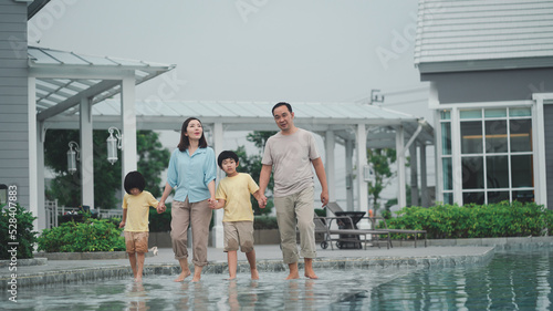 The family is happy because they can relax at a modern style holiday home.Husband and wife seem happy to be together with their children.The summer lifestyle is to take the family on vacation.
