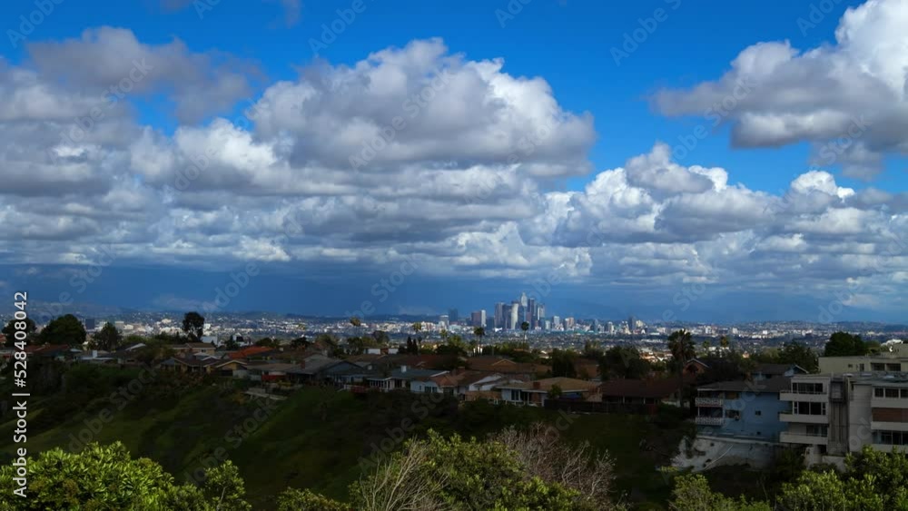 Lockdown Time Lapse Shot Of Clouds Moving Over Residential Buildings In City On Sunny Day - Los Angeles, California Lockdown Time Lapse Shot Of Clouds Moving Over Residential Buildings In City On Sunny Day - Los Angeles, California