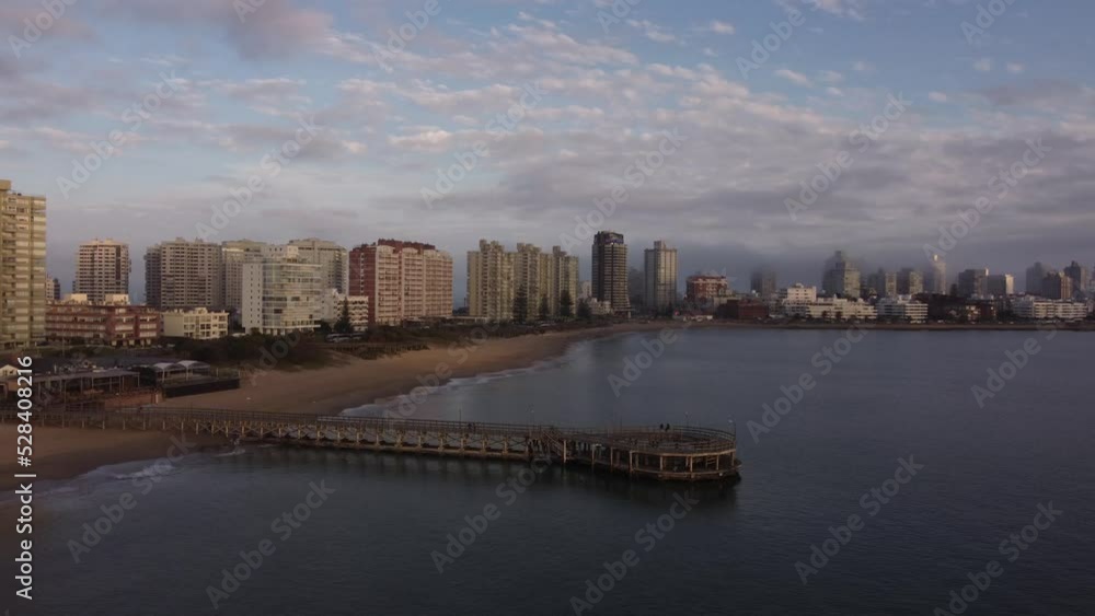 Cinematic drone shot showing jetty and Skyline of Punta del Este Beach at sunset in Uruguay Cinematic drone shot showing jetty and Skyline of Punta del Este Beach at sunset in Uruguay
