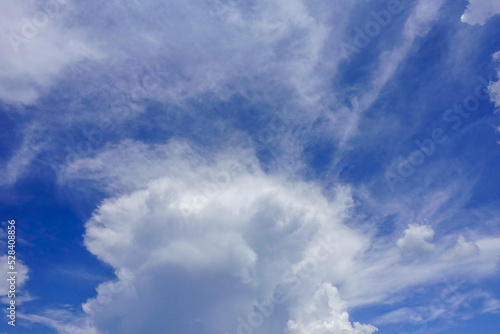 Puffy fluffy white clouds blue sky.