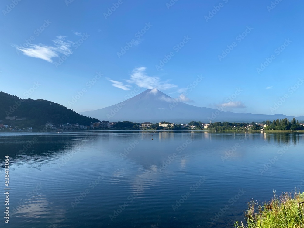 Beautiful thin clouds dances around the top of the Mt. Fuji, the summer view of the clear silhouette of Japanese world heritage, historic landmark, shore of Kawaguchiko Yamanashi, 2022/8/27