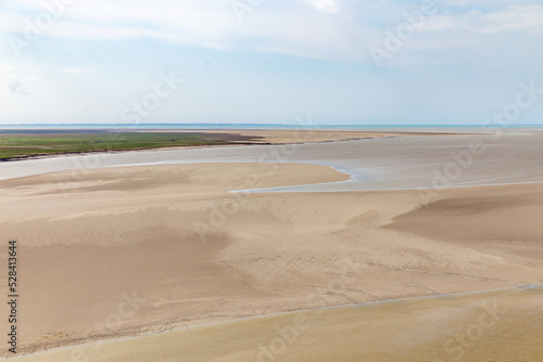 Beautiful view from the Mont Saint-Michel Abbey to the Atlantic Ocean at low tide. France