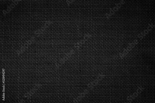 Black fabric canvas texture background. Linen dyed black. Sackcloth woven texture pattern background dark black color.