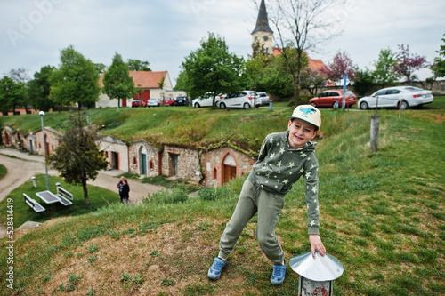 Boy stand at traditional wine cellars outdoor in Vrbice, Czech Republic. photo