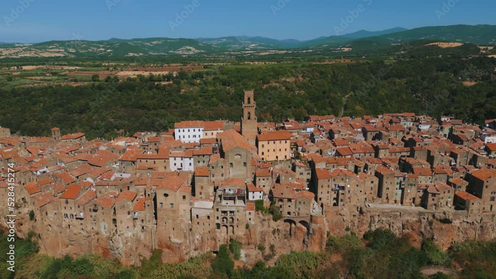 Famous Tuscany town Pitigliano, built on Etruscan tufa rocks with old medieval buildings near scenic Siena and Florence, Italy. Close to wine and vinery area, seen from above by drone as aerial view. Famous Tuscany town Pitigliano, built on Etruscan tufa rocks with old medieval buildings near scenic Siena and Florence, Italy. Close to wine and vinery area, seen from above by drone as aerial view.