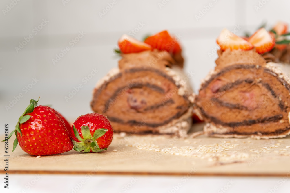 Rolled with fruits. Wonderful dessert. Homemade cake roll with chocolate and fresh strawberry. Chocolate swiss cake. Sweet roll cake. Chocolate strawberry roll cake. Sponge roll with blueberries Rolled with fruits. Wonderful dessert. Homemade cake roll with chocolate and fresh strawberry. Chocolate swiss cake. Sweet roll cake. Chocolate strawberry roll cake. Sponge roll with blueberries