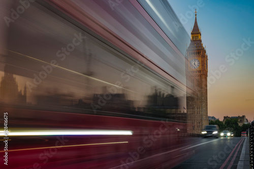 Bus speeds past Big Ben at dawn