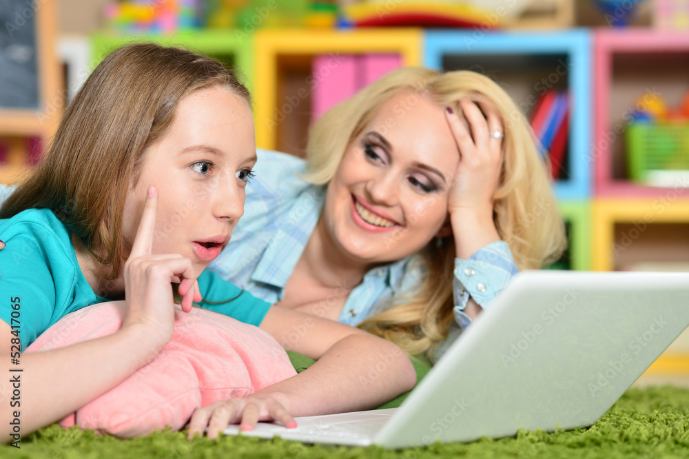 Young woman with girl using laptop Young woman with girl using laptop