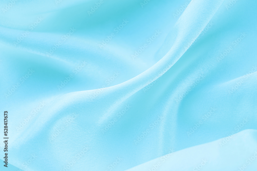 folds of blue silk fabric texture background folds of blue silk fabric texture background