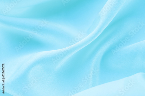 folds of blue silk fabric texture background © Iryna_B
