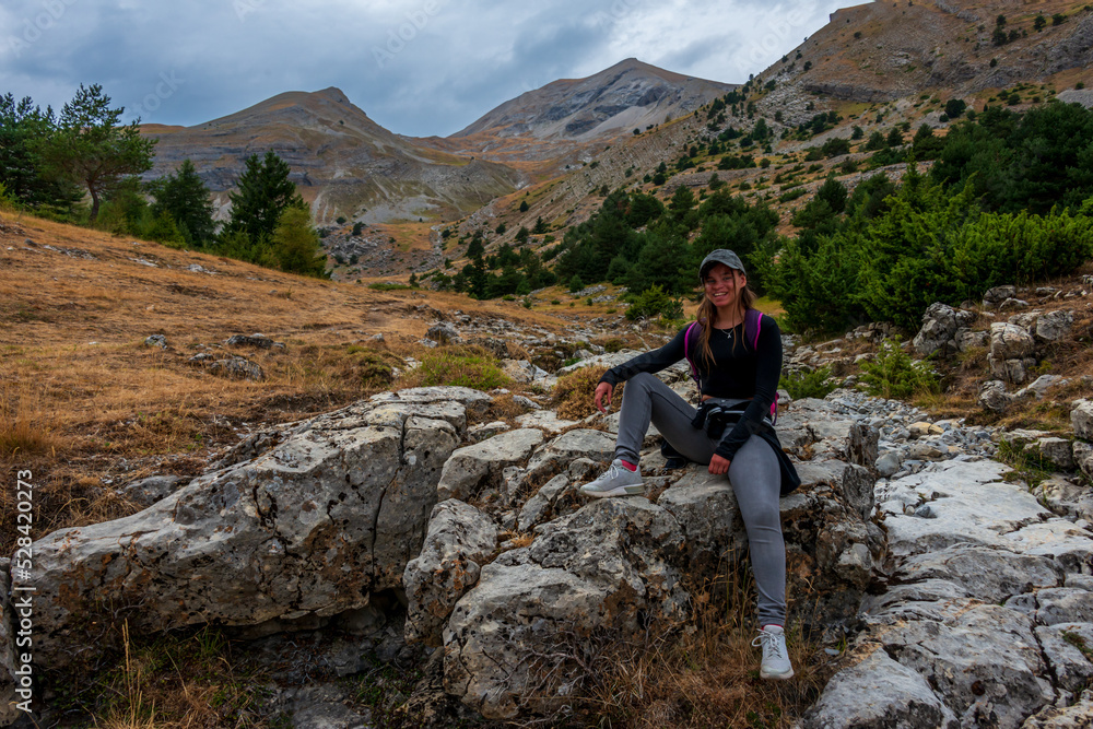 young woman relaxing in the mountains , adventure holidays lifestyle . France alps .
