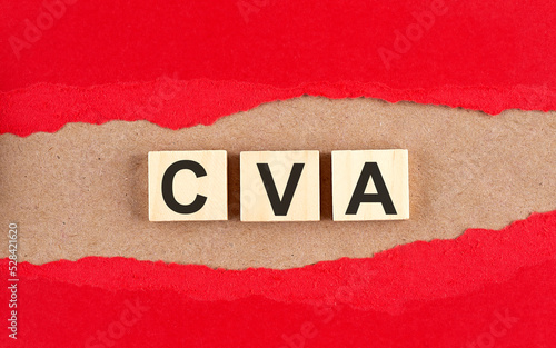 CVA word on wooden cubes on red torn paper , financial concept background