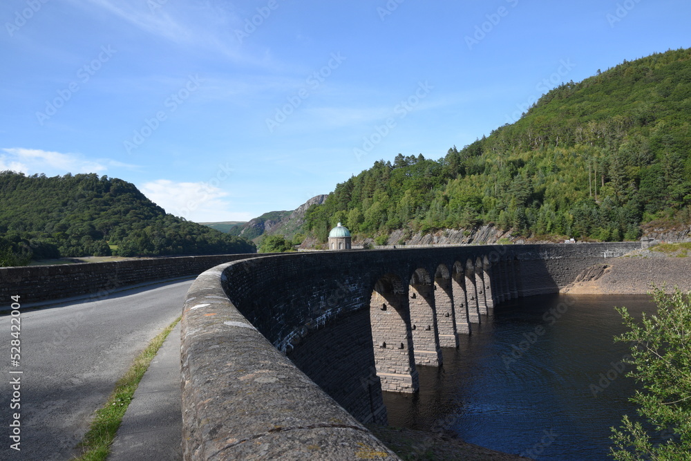 Garreg Ddu dam at elan valley during the 2022 heatwave with the water level almost low enough to see the submerged dam under the bridge