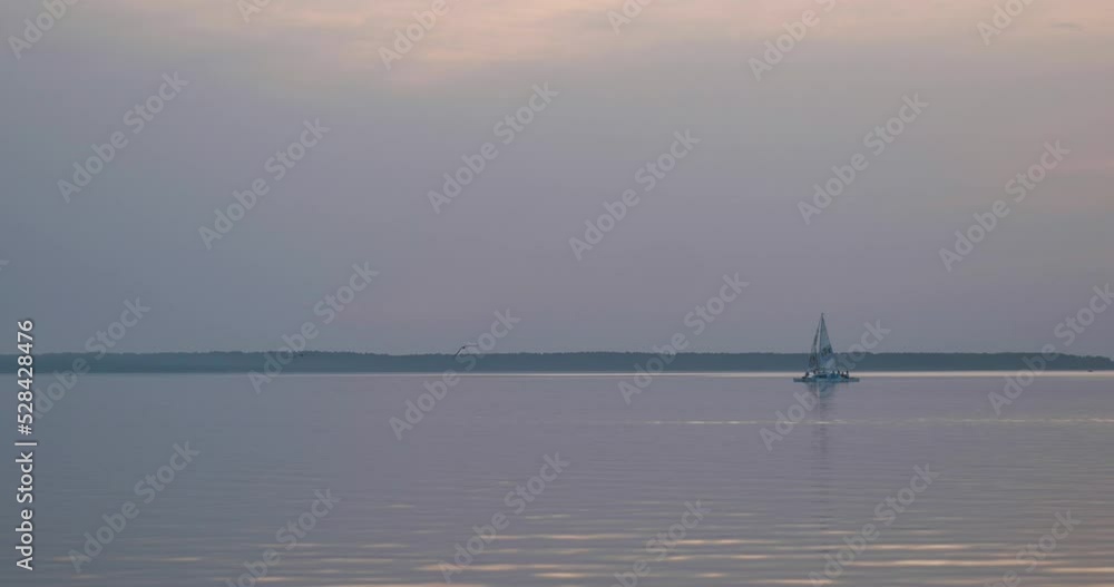 Lonely sail. Serene water scape and transportation Lonely sail. Serene water scape and transportation