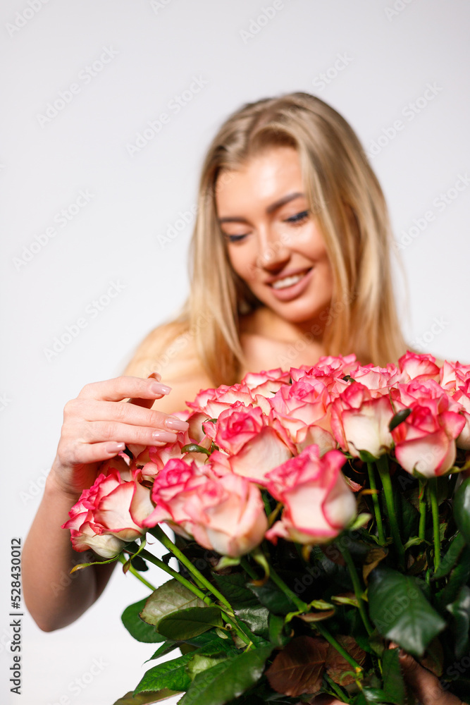 Close up of bouquet of roses on background of young sexy and sensual women. Close up of bouquet of roses on background of young sexy and sensual women.