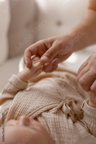 New born baby hand hold mum index finger. Mother and baby.