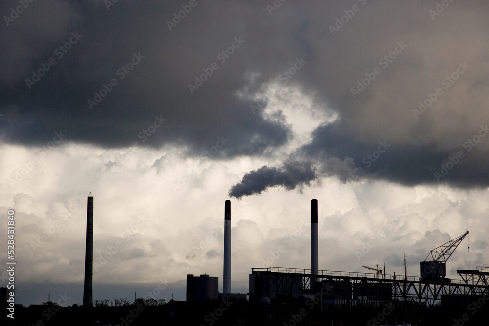 silhouettes of chimneys with a cloudy sky
