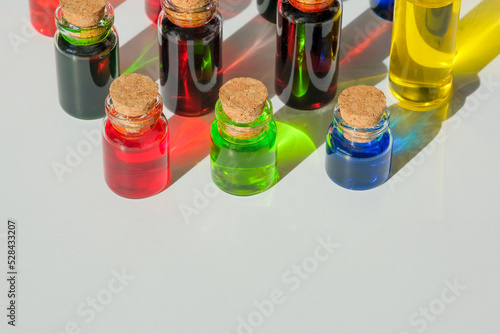 A row of bottles with red, green and blue color. A palette of paints for the artist. Interior design development.