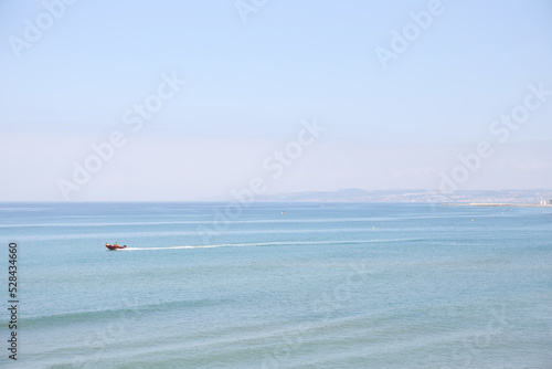 Beautiful seascape. View of the sea surface of the water with the motorboat in a blurred focus. Alboran Sea coast, Mediterranean Sea. Estepona, Spain. photo